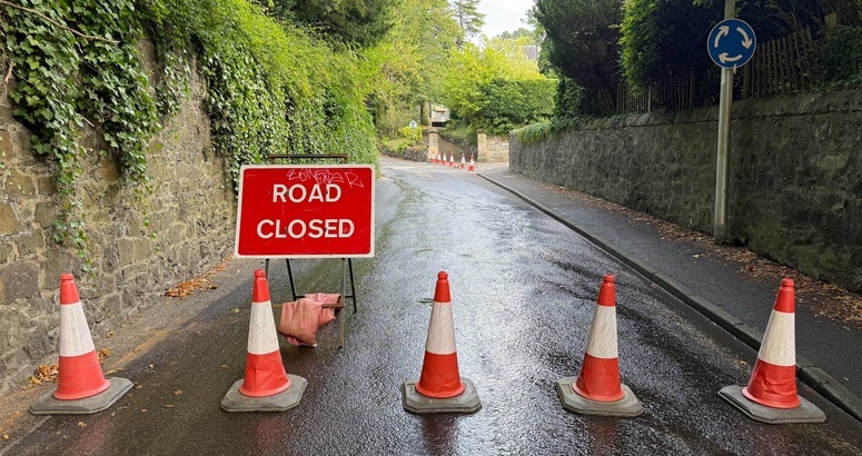 Road with orange cones and road closed sign