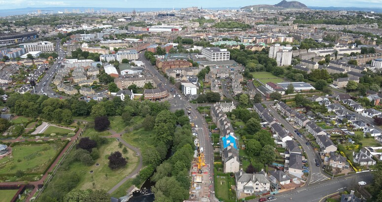 An aerial shot of Edinburgh, with a major construction project visible in the foreground