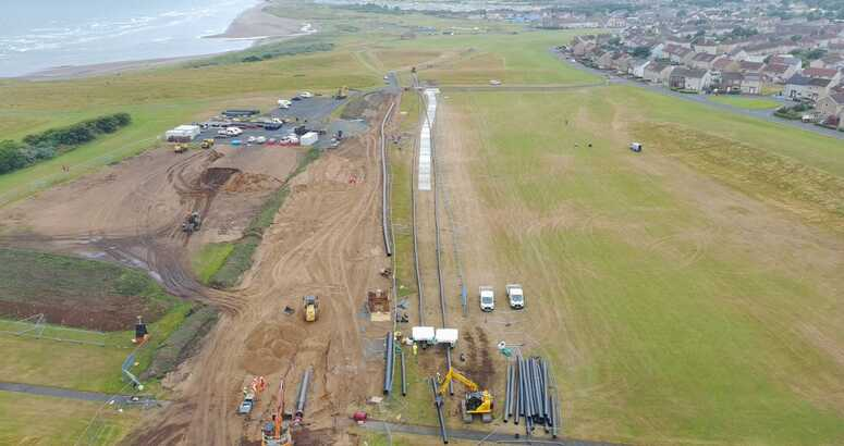 An aerial shot showing new sections of pipe ready to be installed