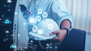 Man with hard hat in front of computer 