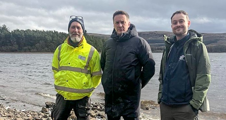 2x members of the Scottish Water Land Strategy Team pictured either side of the Watch Commander from Scottish Fire and Rescue, pictured on the shore just in front of Gladhouse Reservoir. Scenic background.