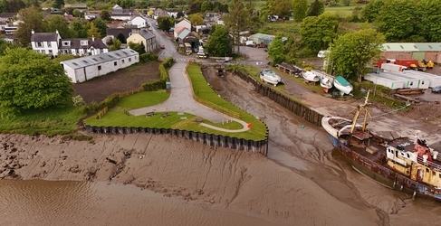 Drone footage of harbour with water and boats docked