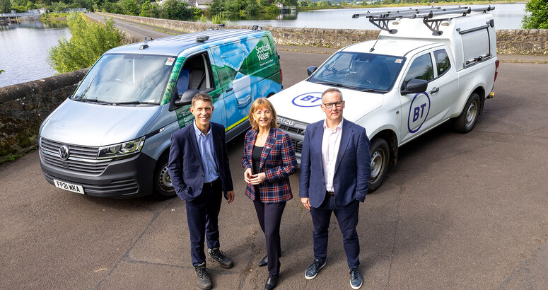 three people standing in front of two branded vehicles with Milngavie Reservoir in the background to announce the new digital partners for Scottish Water