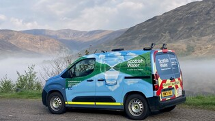 a Scottish Water branded small van in front of a beautiful mountain backdrop on road near to Fort William