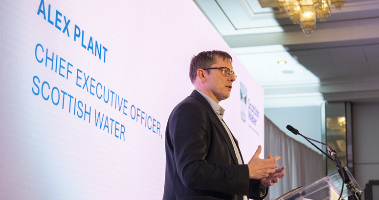 Alex Plant giving keynote speech at lecturn