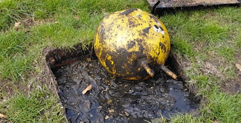 dirty yellow space hopper in an uncovered sewer
