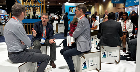 Scottish Water CEO Alex Plant chatting with two delegates at IWA 2024 in Toronto