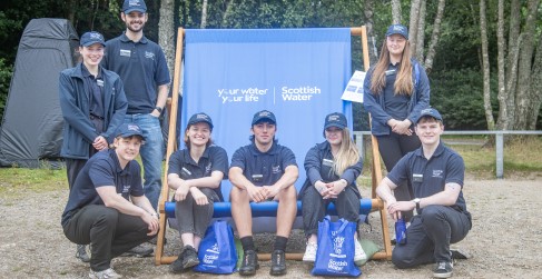 Scottish Water Employees Pose on Blue Branded Deck Chair