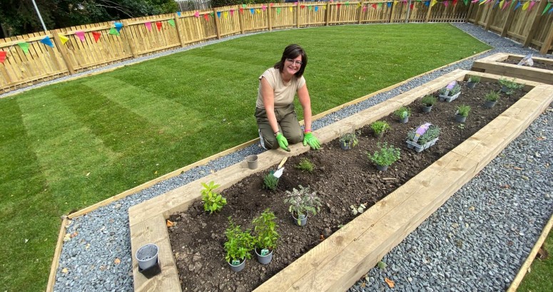 Charlotte Chiswick, Redhall School Head Teacher shown carrying out gardening work in new space.