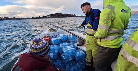 Workers on open boat to Easdale with repair kit and bottled water after storm Eowyn