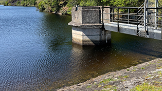 reservoir edge  with water tower showing low water line with water tower